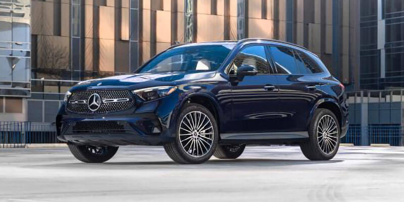 Mercedes-Benz SUV parked outside a modern building with a sleek blue exterior and stylish alloy wheels.